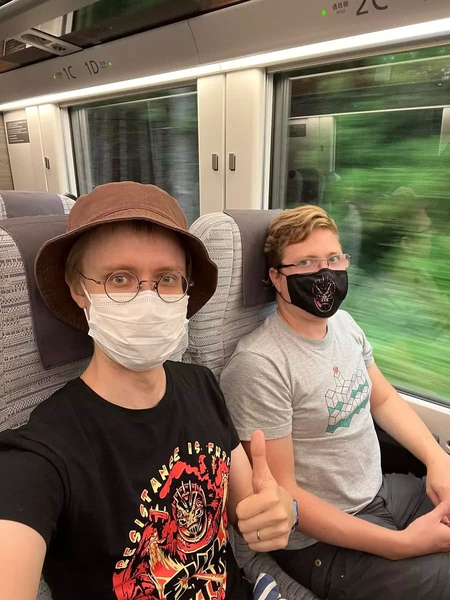 Sampo gives a thumbs up as he and Andrey ride on a train