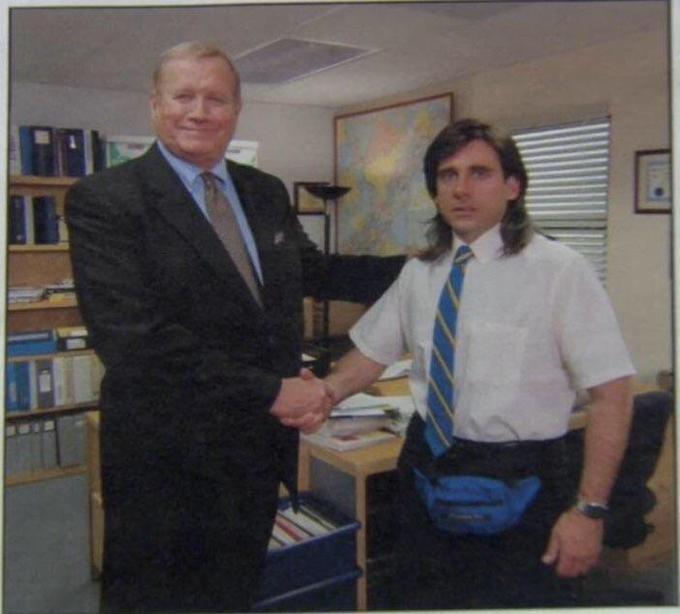 Picture showing a memorable moment from the American television comedy series The Office where Michael Scott is shaking a hand of his former boss.