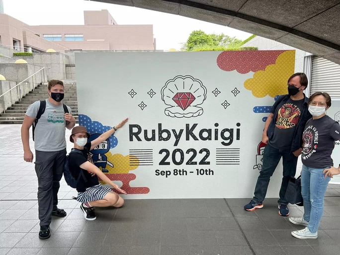 The Evil Martians from the Japanese office pose in front of a RubyKaigi 2022 sign
